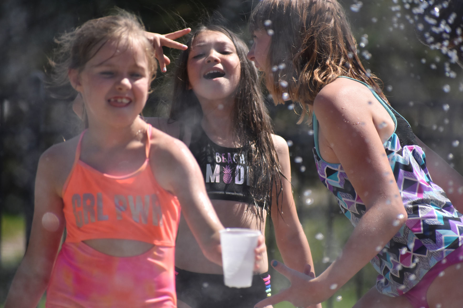 Friends together at splash pad in Portage